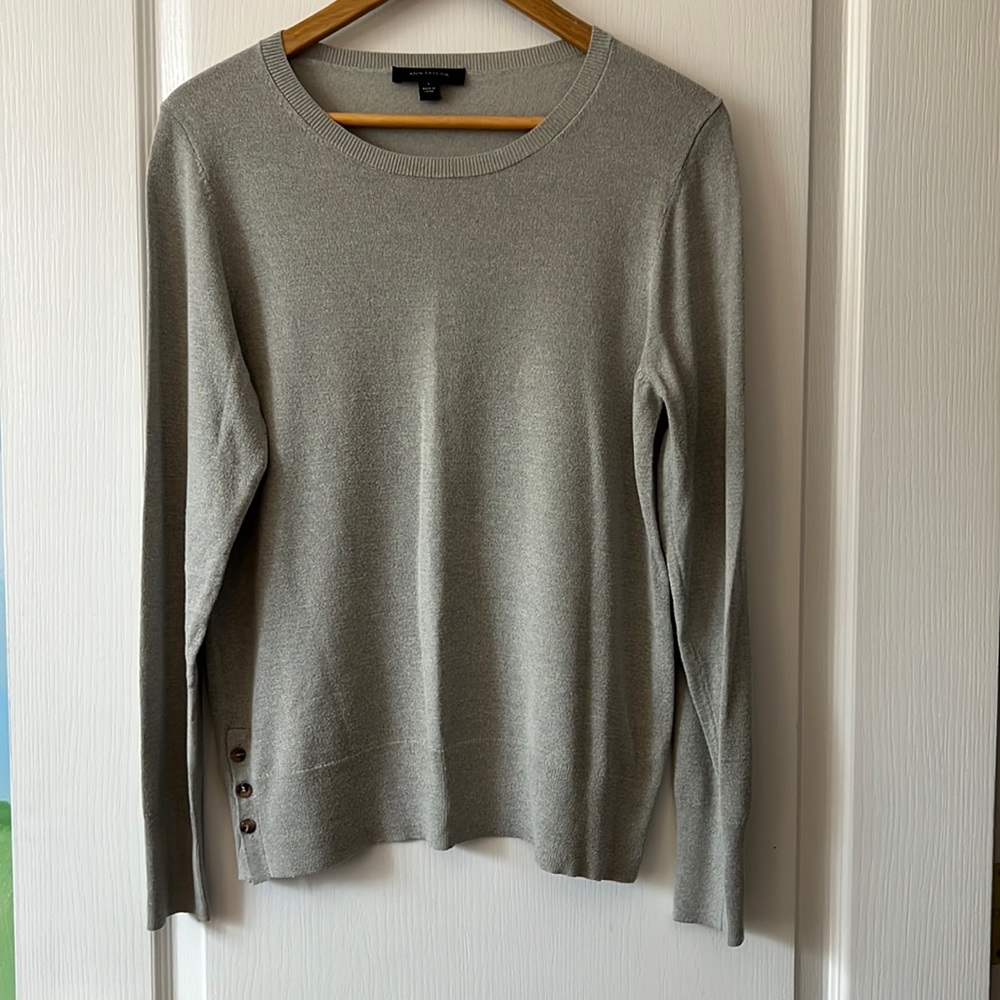 Ann Taylor sweater. Size Lg. in a light gray color. 3 button detailing at bottom